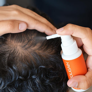 FOLIGAIN TRIOXIDIL topical treatment being applied directly to a parted scalp